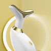 A white electric facial lifting and firming massager is displayed on a gold-colored stand.