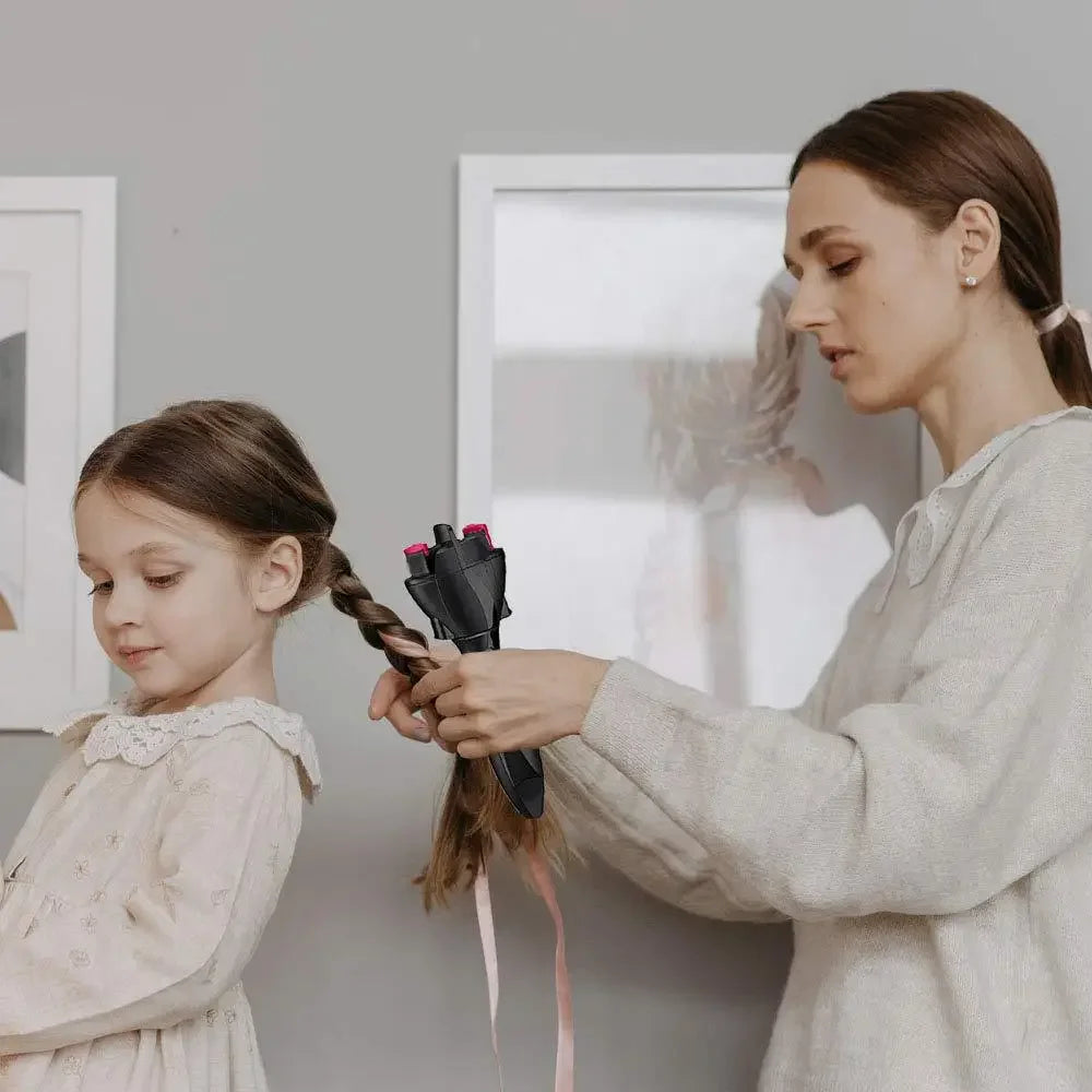 A woman is using an electric twist braiding tool to style a child's hair.