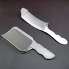A set of professional flat top hair cutting combs, including a wide comb and a narrower comb, displayed on a dark surface.