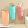 Three heat resistant silicone silicone storage bags in peach, turquoise, and pink hanging on a wall.