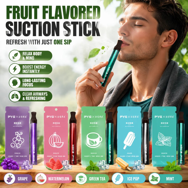 A man inhales a fruit-flavored suction stick while surrounded by fresh fruit and herbs.