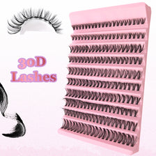 A pink plastic lash tray filled with black natural long individual lashes.
