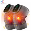 A gray electric knee massager and heat therapy pad is shown glowing with orange light on a white background.