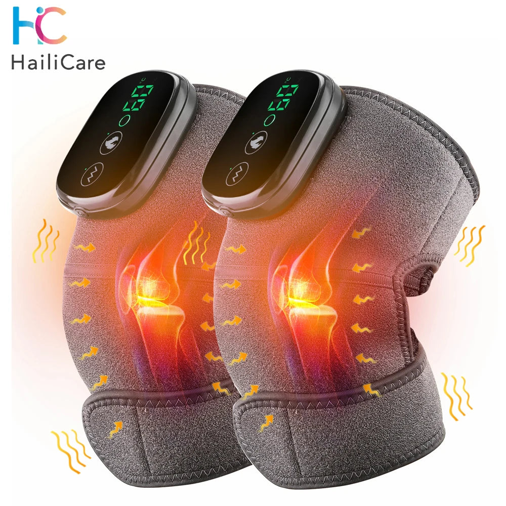 A gray electric knee massager and heat therapy pad is shown glowing with orange light on a white background.