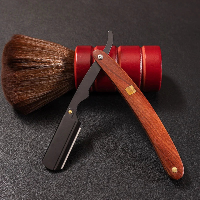 A professional shaving razor with a wooden handle and a bronze-colored metal blade is shown next to a brush and a red cylindr