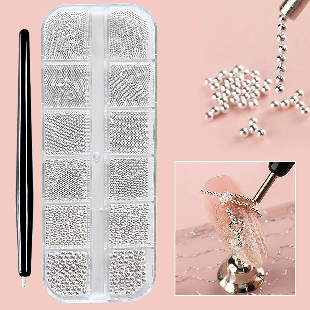 A clear plastic case containing various gold mixed stainless steel bead nail art decorations and a black nail tool.