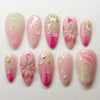 Un set de 10 uñas postizas brillantes rosa y blanco con delicados diseños de mariquita.