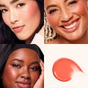 Close-up of a woman applying Soft Pinch Liquid Blush Joy on her cheek and face.