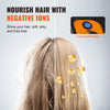 A woman's hair is being dried using an ionic hood, showing glowing ions on the strands.