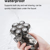 A hand holds a waterproof electric shaver rinsing under a faucet.
