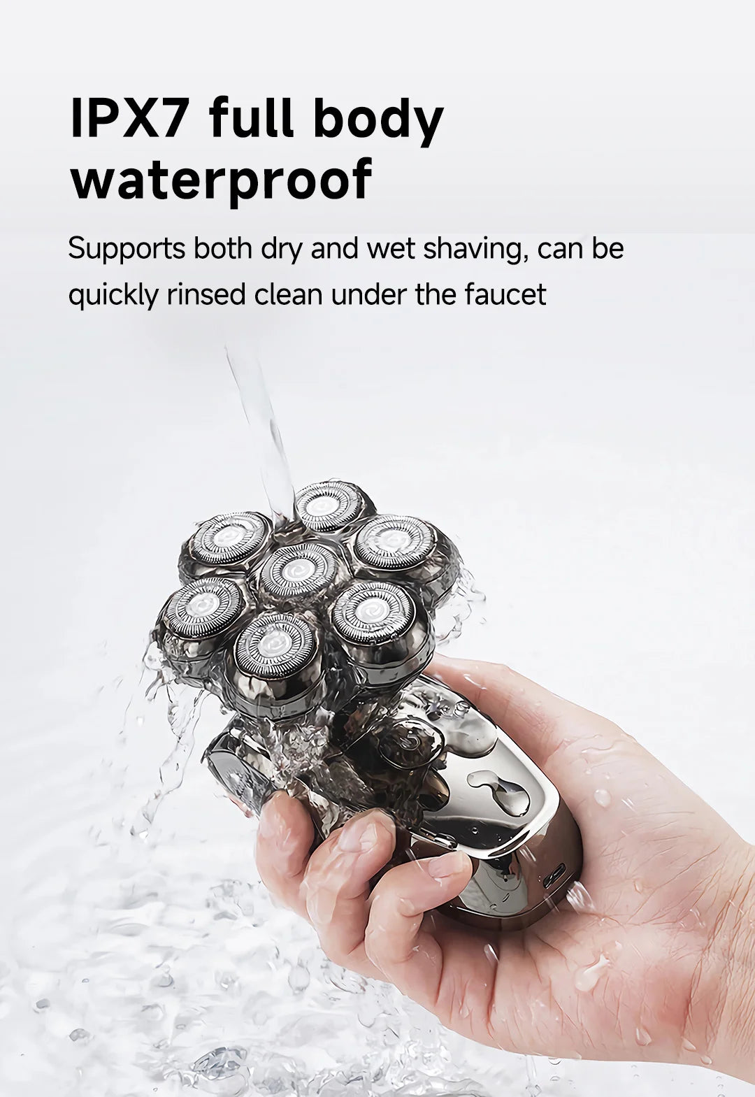 A hand holds a waterproof electric shaver rinsing under a faucet.