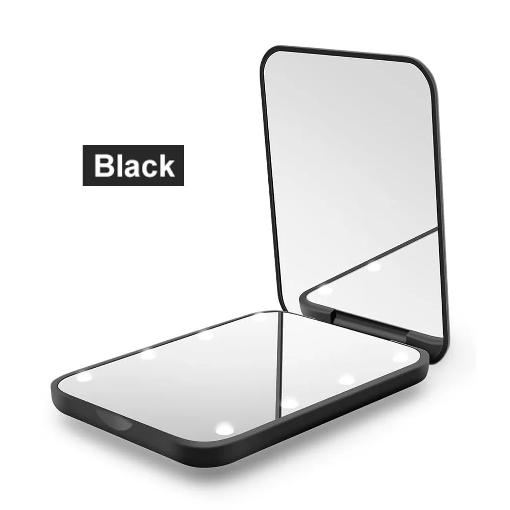 A black portable LED magnifying makeup mirror shown in an open, flat display.