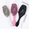 Three hair styling combs with pink and black bristles shown next to a measurement ruler.