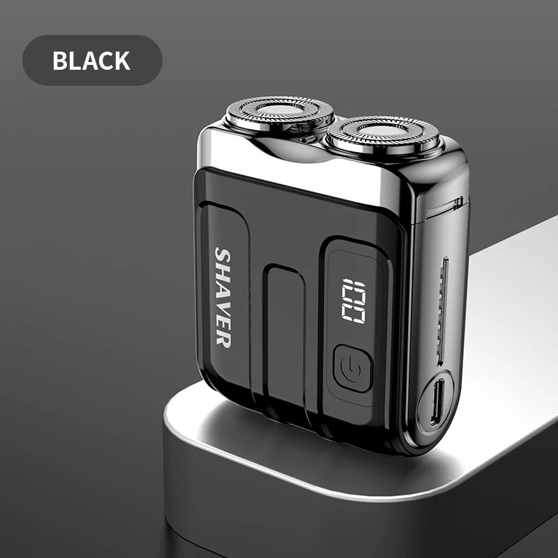 A black mini electric smart shaver resting on a light gray surface.