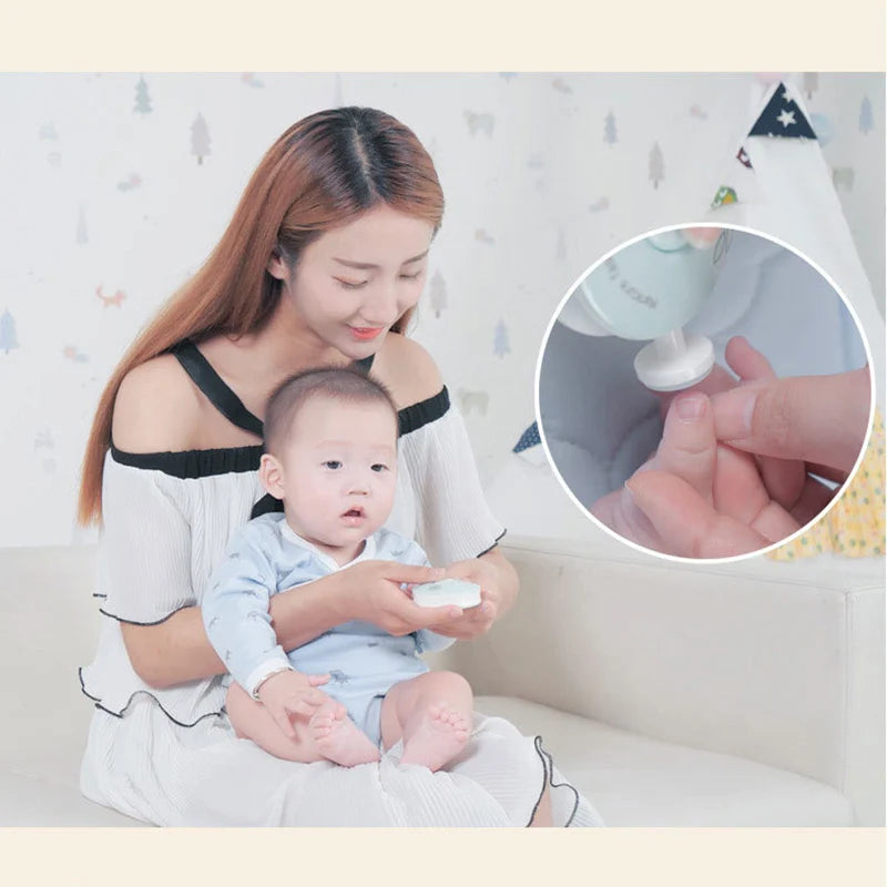 A woman gently applies a white substance to a baby's fingernails using a gentle electric tool for nail care.