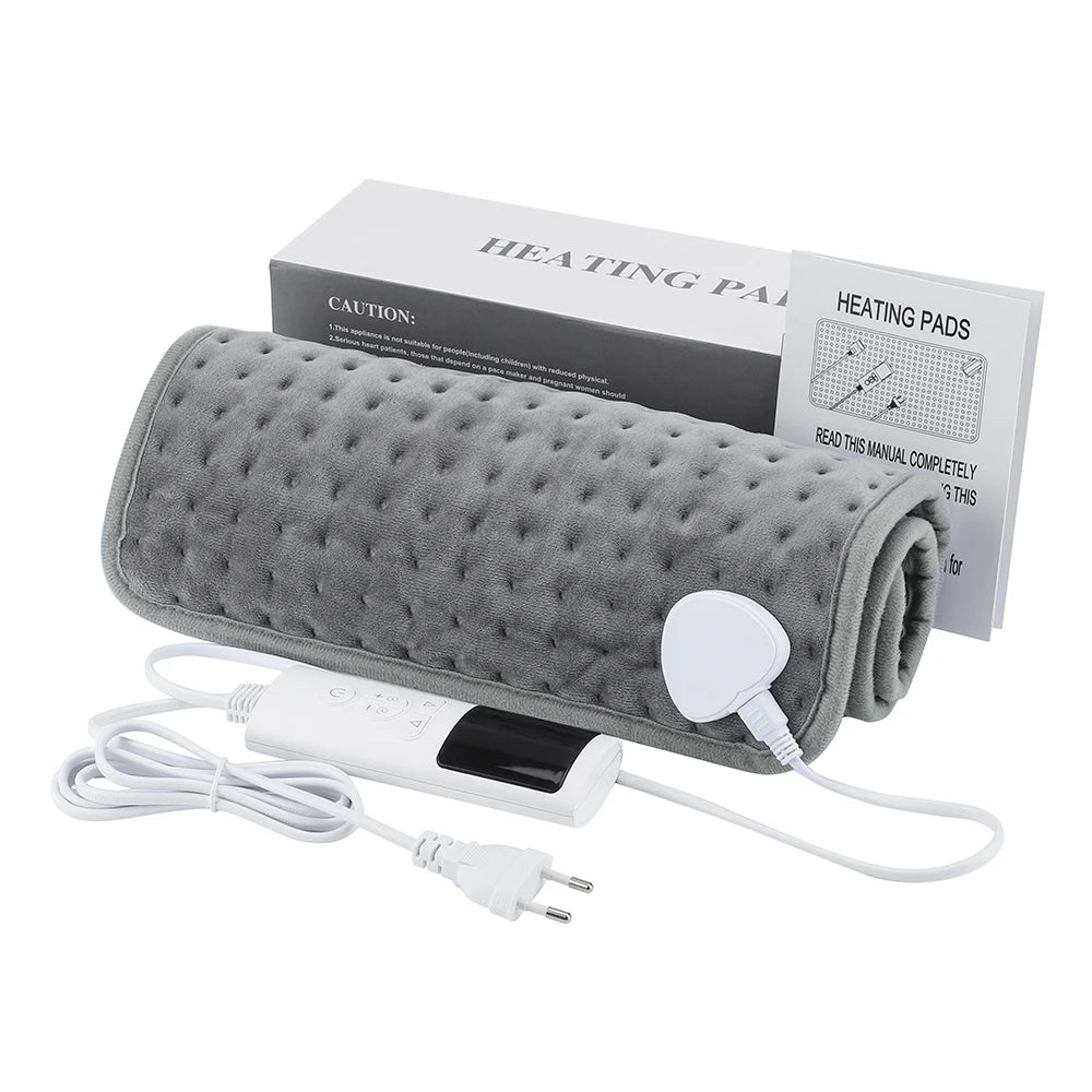 A gray electric heating pad with a cord and manual is shown next to its packaging.