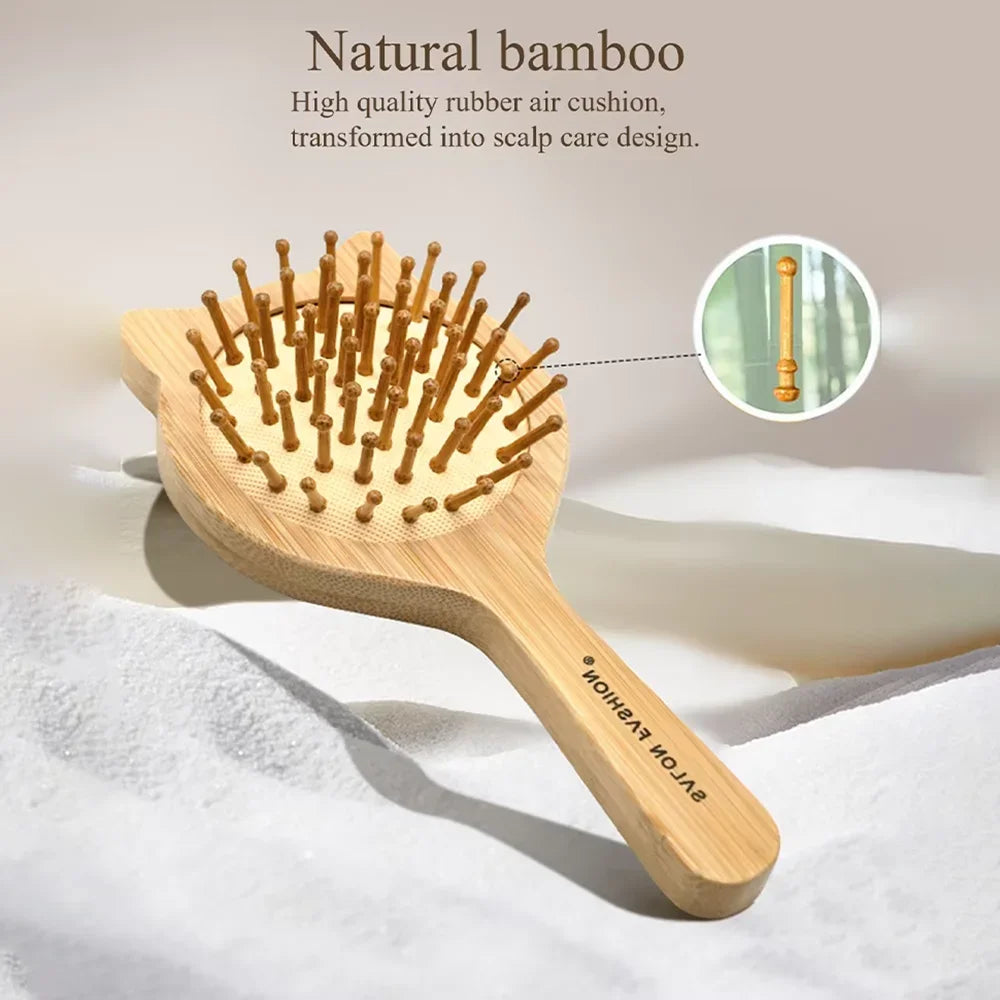 A wooden bamboo hair brush with numerous bristles is shown on a white surface.