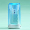 A clear electric toothbrush with a blue light, featuring a curved head and a textured body.