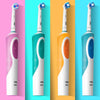A set of four Oral-Style electric toothbrushes in various colors including purple, teal, orange, and blue.