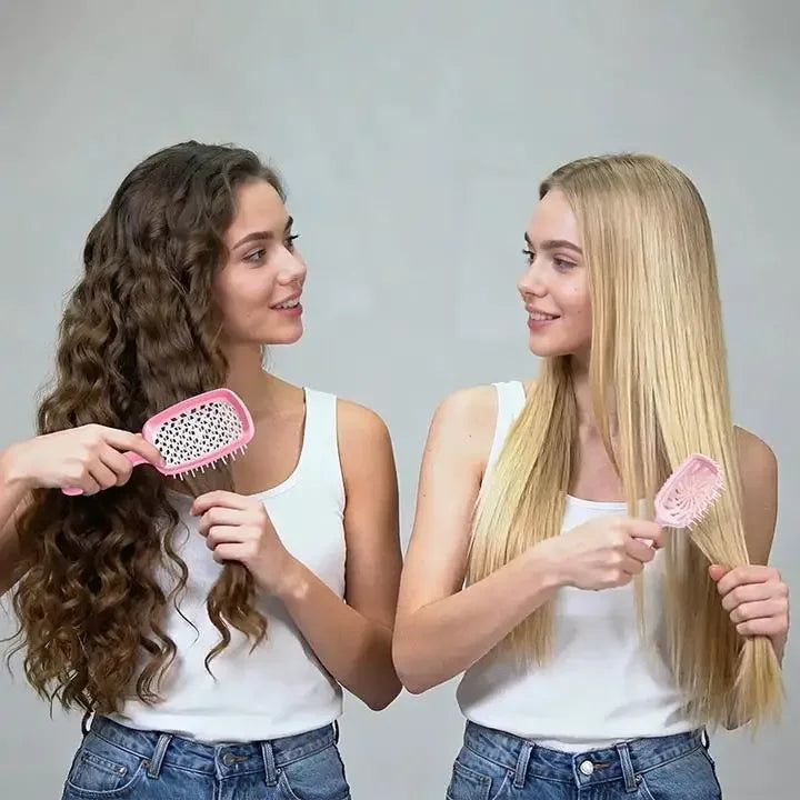 Two young women show off long hair using a pink detangling hair comb.
