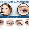 A double-sided magnifying mirror showing 1X and 30X magnification capabilities for examining skin and eyes.