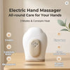 Weißer elektrischer Handmassager mit verschiedenen Massagefunktionen auf einer Holzoberfläche.