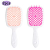 A pair of professional detangling hair brushes, one in pink and one in bright pink.