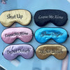 Four embroidered silk sleep masks in various colors including gold, black, pink, and blue.