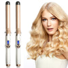 A woman models a professional electric hair curler with gold and silver components.