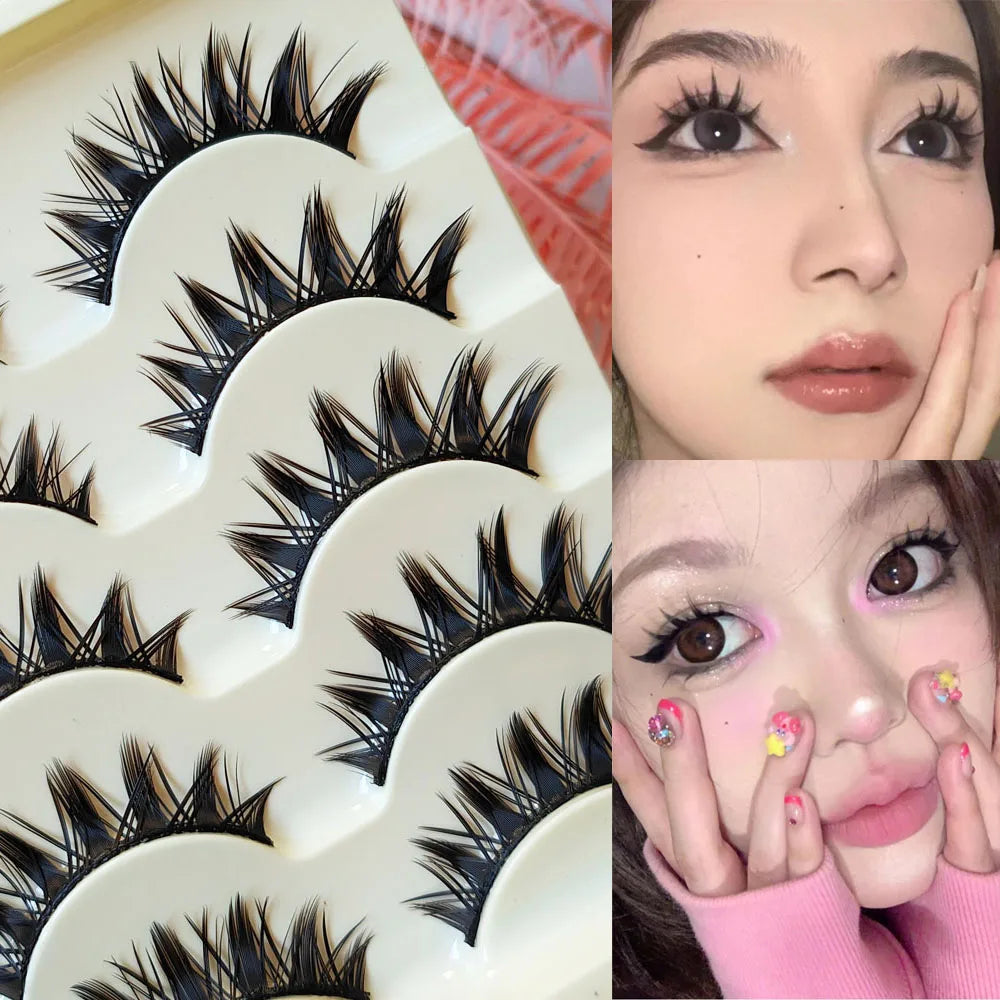 A collection of black false eyelashes in various styles and lengths displayed on a white tray.