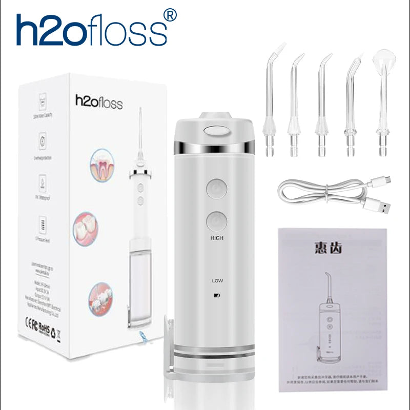 A white portable water flosser device and various tips are shown in a product box context.