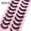Plateau en plastique rose contenant diverses styles de faux cils de renard noir.