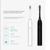 A white and black sonic electric toothbrush shown with three different brush heads.