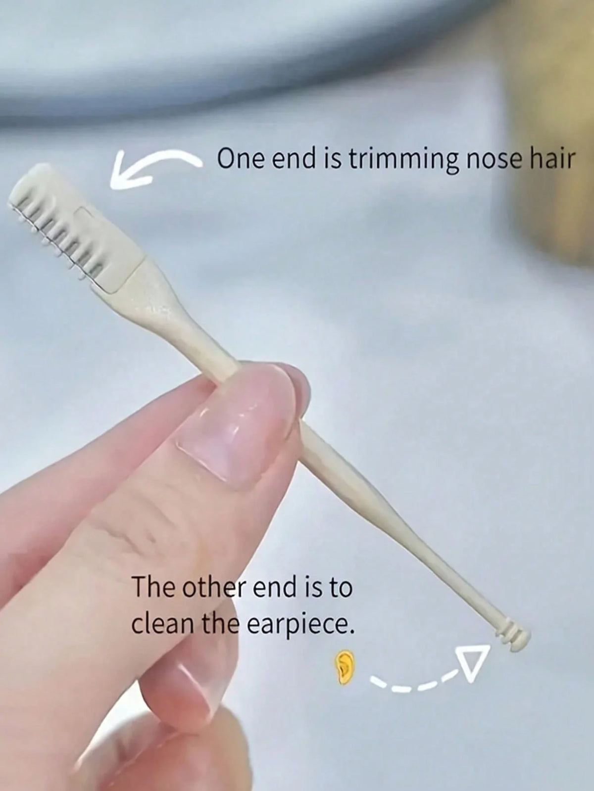 A hand holds a double-headed manual nose hair trimmer, showing one end trimming nose hair and the other cleaning the earpiece