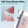 A close-up of a portable oral irrigator device being used on a tooth, demonstrating its function for removing dental residue.
