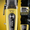 A yellow Kemei electric hair clipper with a black body and gold accents, shown next to charging accessories.