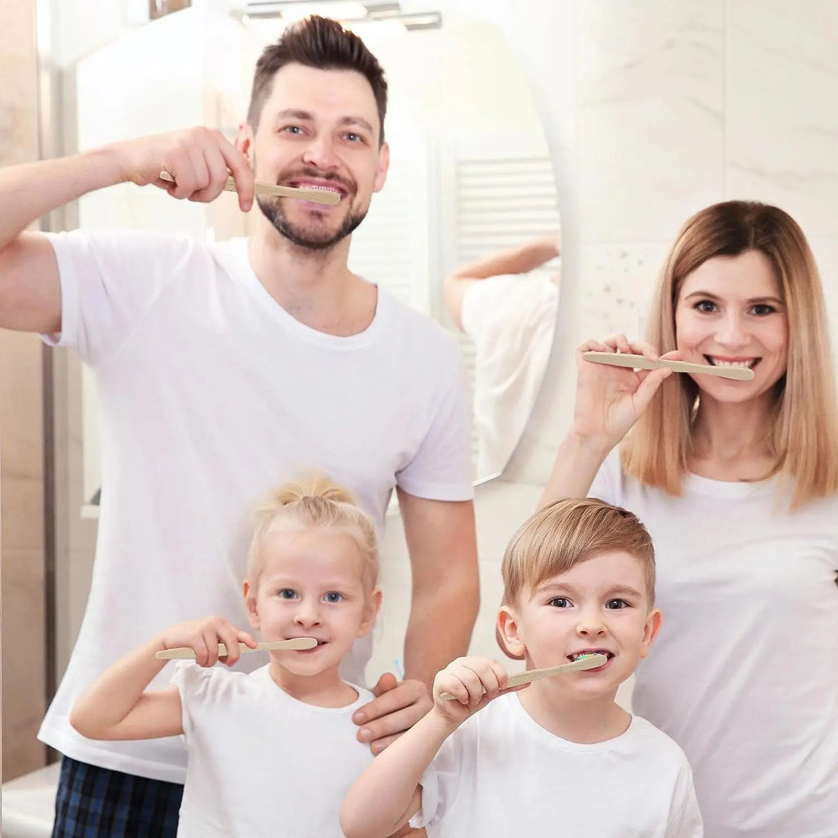 A family of three smiling while using eco-friendly bamboo toothbrushes