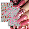 A set of pink and green flower butterfly nail stickers for DIY decoration shown on a hand.