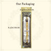 A long wooden miswak toothbrush packaged in a rectangular paper sleeve.