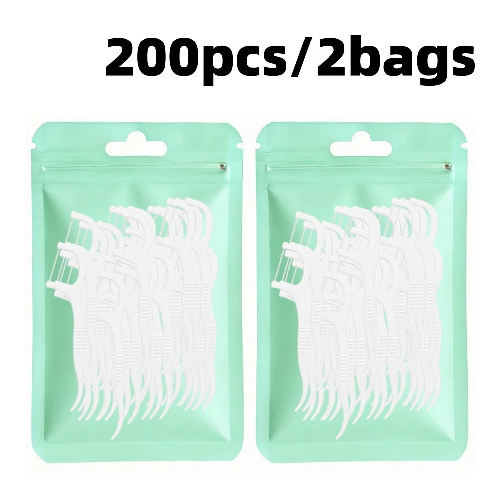200 pieces of white reusable dental floss picks packaged in two bags