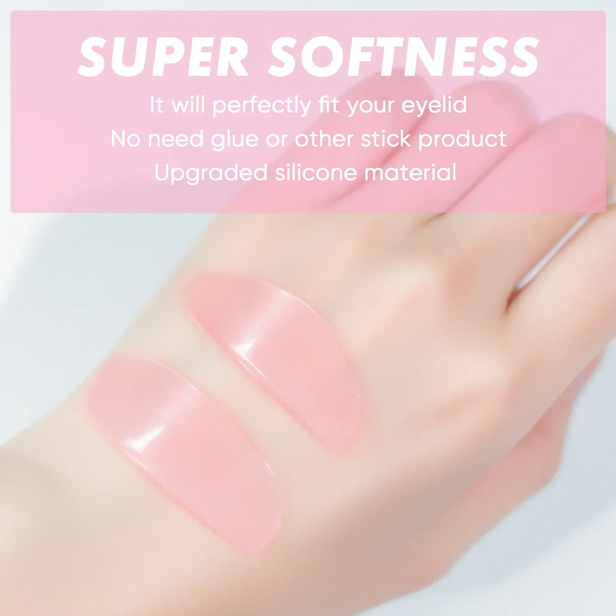 Close-up of a hand applying pink silicone lash lift pads to an eyelid for a soft look.