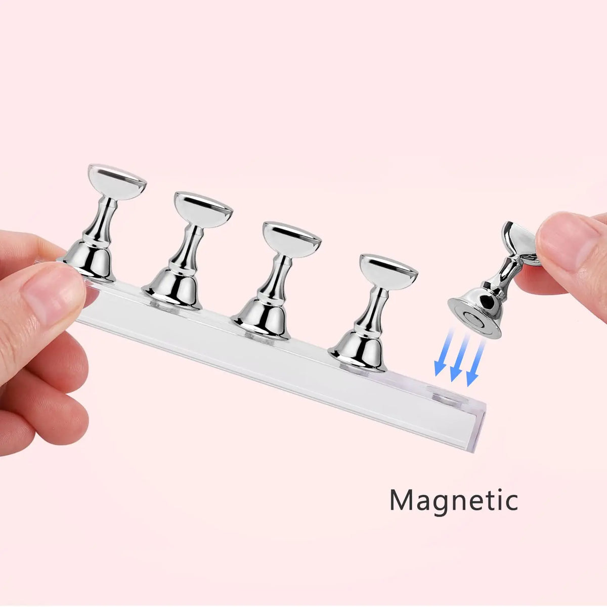 A hand holds a clear acrylic display stand with five magnetic nail art tools attached.