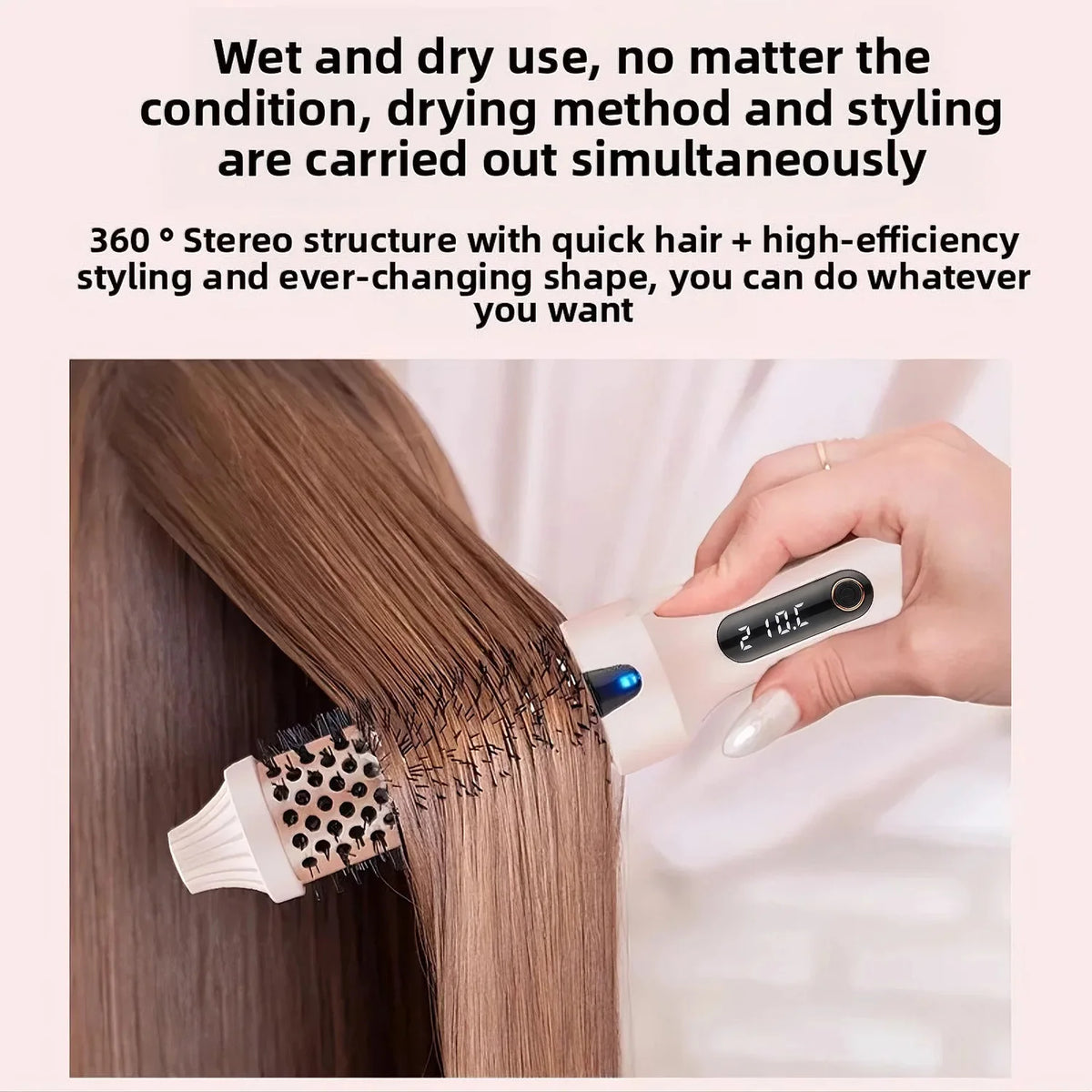 A hand is using a white heated round hair brush on a strand of straight brown hair.