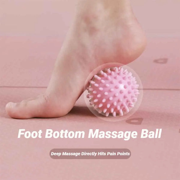 A pink textured foot massage ball is shown next to a bare foot on a pink surface.