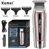 A silver Kemei hair clipper with various guard attachments shown next to its packaging.