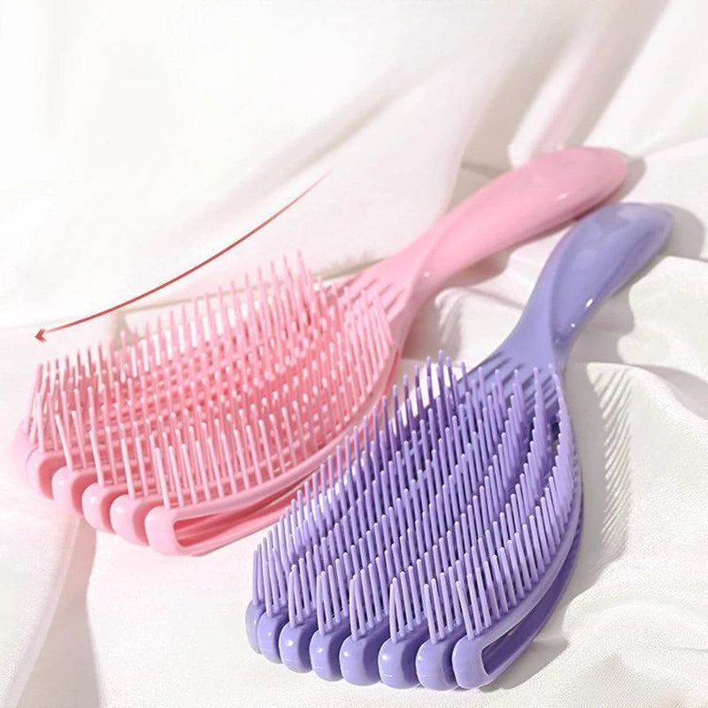 A pink massage detangler hair brush for curly and thick hair is shown against a white background.