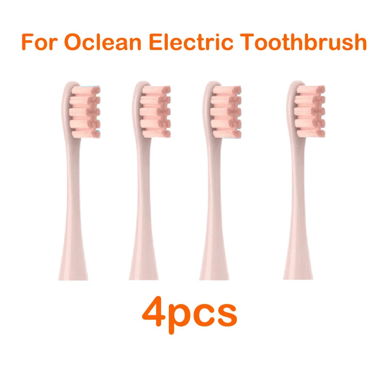 Four replacement brush heads for an Ocean electric toothbrush in a light pink color.
