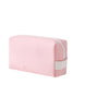 A pink waterproof PU leather makeup bag with a white color block design.