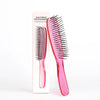 A pink scalp brush for professional hair detangling displayed next to its packaging.