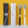 A set of reusable tongue cleaner brushes in black and white packaging displayed against a yellow background.